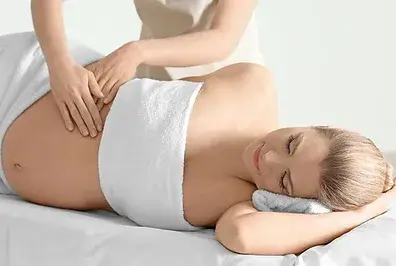 Gentle prenatal lymphatic drainage massage performed by a professional therapist